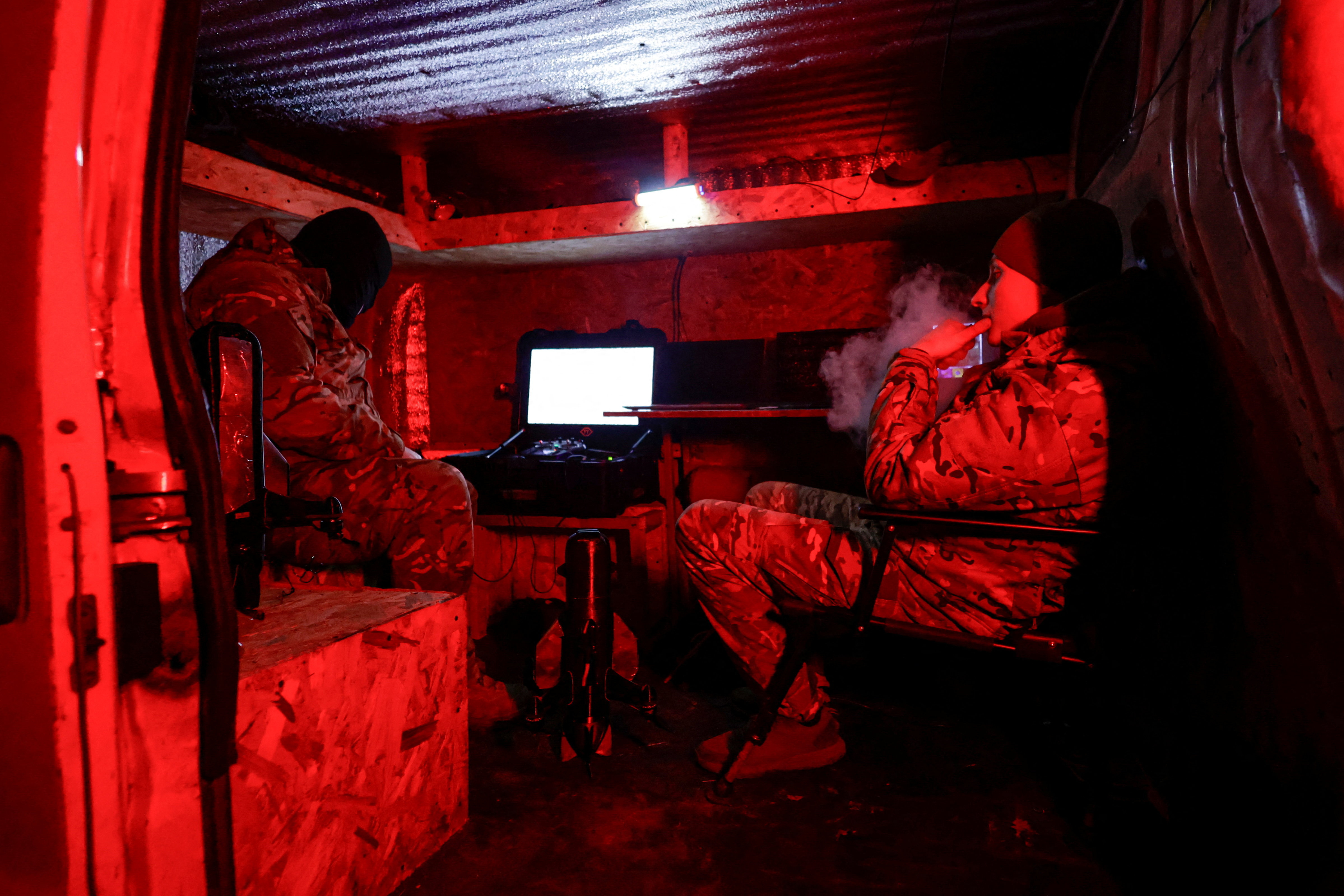 Ukrainian servicemen of an air defence unit wait inside a van during their combat shift near the frontline town of Kupiansk