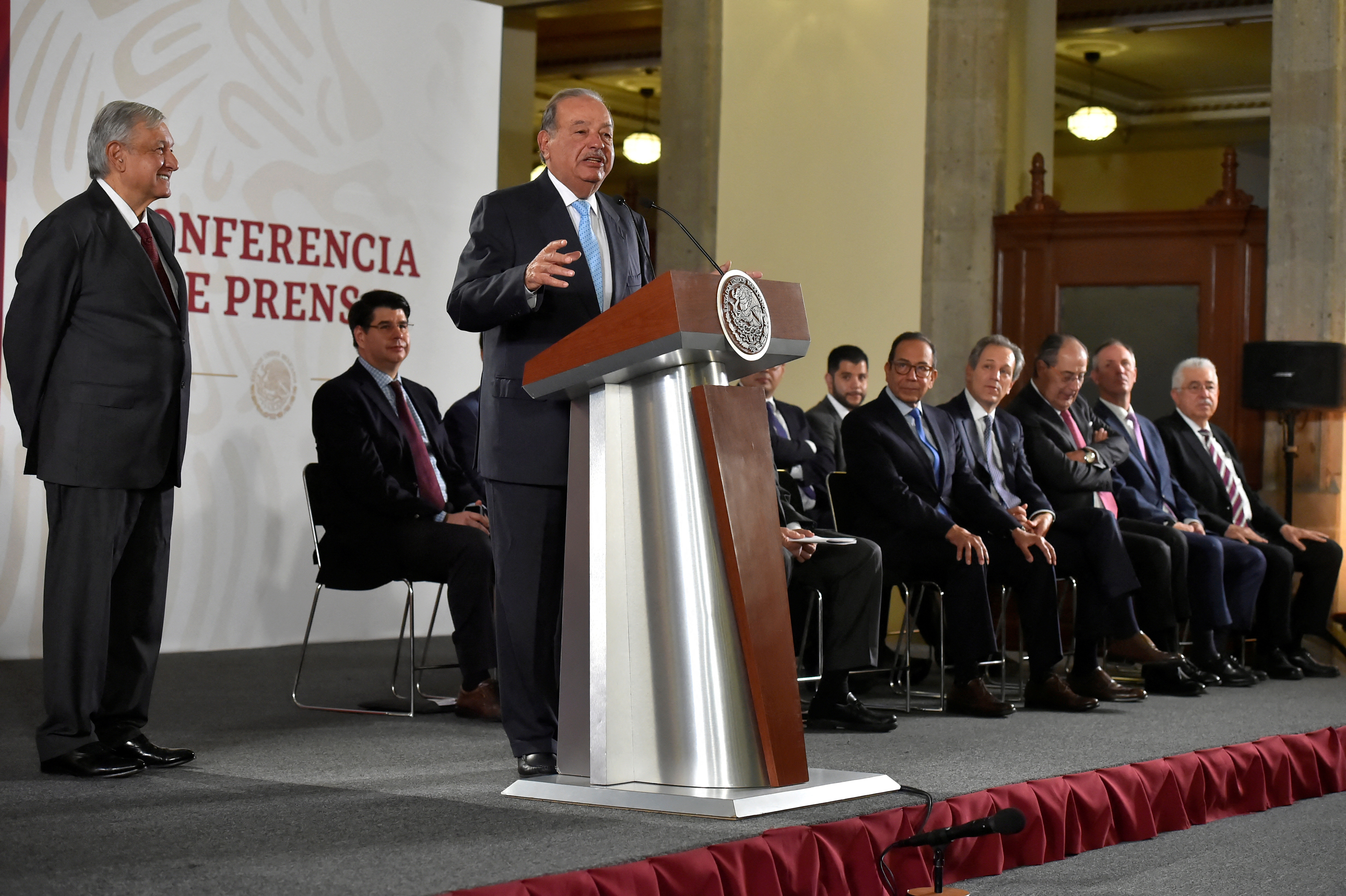 FILE PHOTO: Mexican tycoon Carlos Slim speaks as Mexico's President Andres Manuel Lopez Obrador looks on during an event in Mexico City