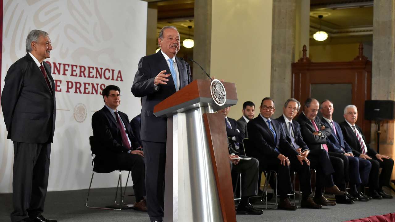FILE PHOTO: Mexican tycoon Carlos Slim speaks as Mexico's President Andres Manuel Lopez Obrador looks on during an event in Mexico City
