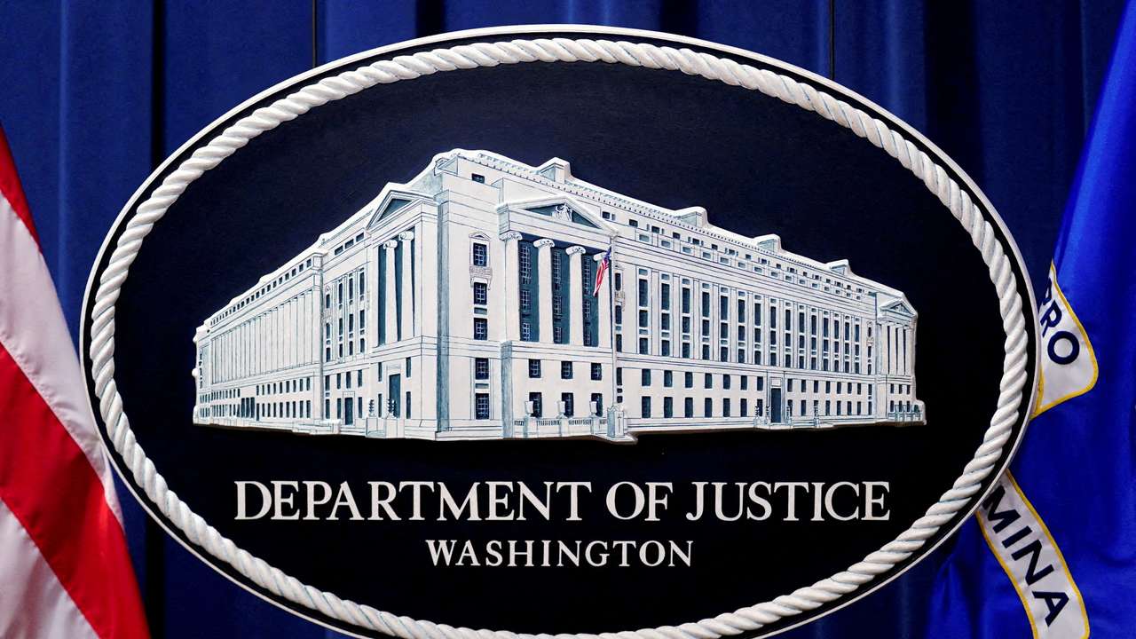 FILE PHOTO: A U.S. Justice Department logo or seal showing Justice Department headquarters, known as "Main Justice," is seen behind the podium in the Department's headquarters briefing room, January 24, 2023. REUTERS/Kevin Lamarque/