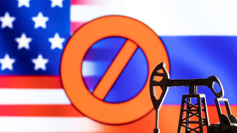 Illustration shows pump jack in front sign "stop", U.S. and Russia flag colours