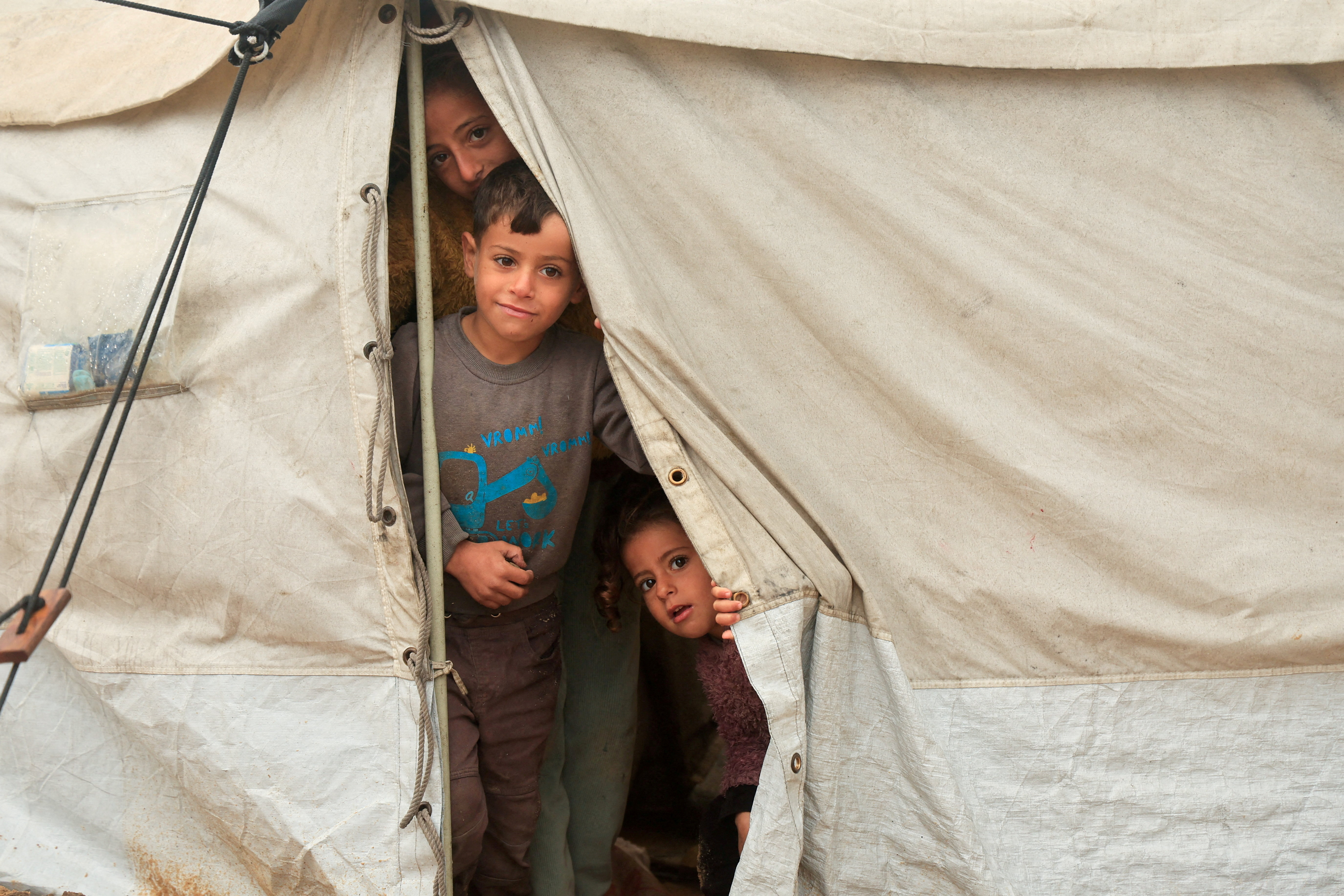 FILE PHOTO: FILE PHOTO: Displaced Palestinians shelter in a tent camp on a rainy day in Khan Younis