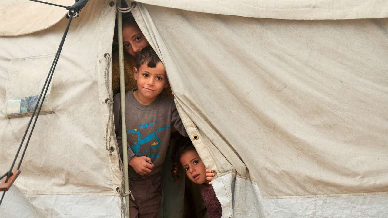 FILE PHOTO: FILE PHOTO: Displaced Palestinians shelter in a tent camp on a rainy day in Khan Younis
