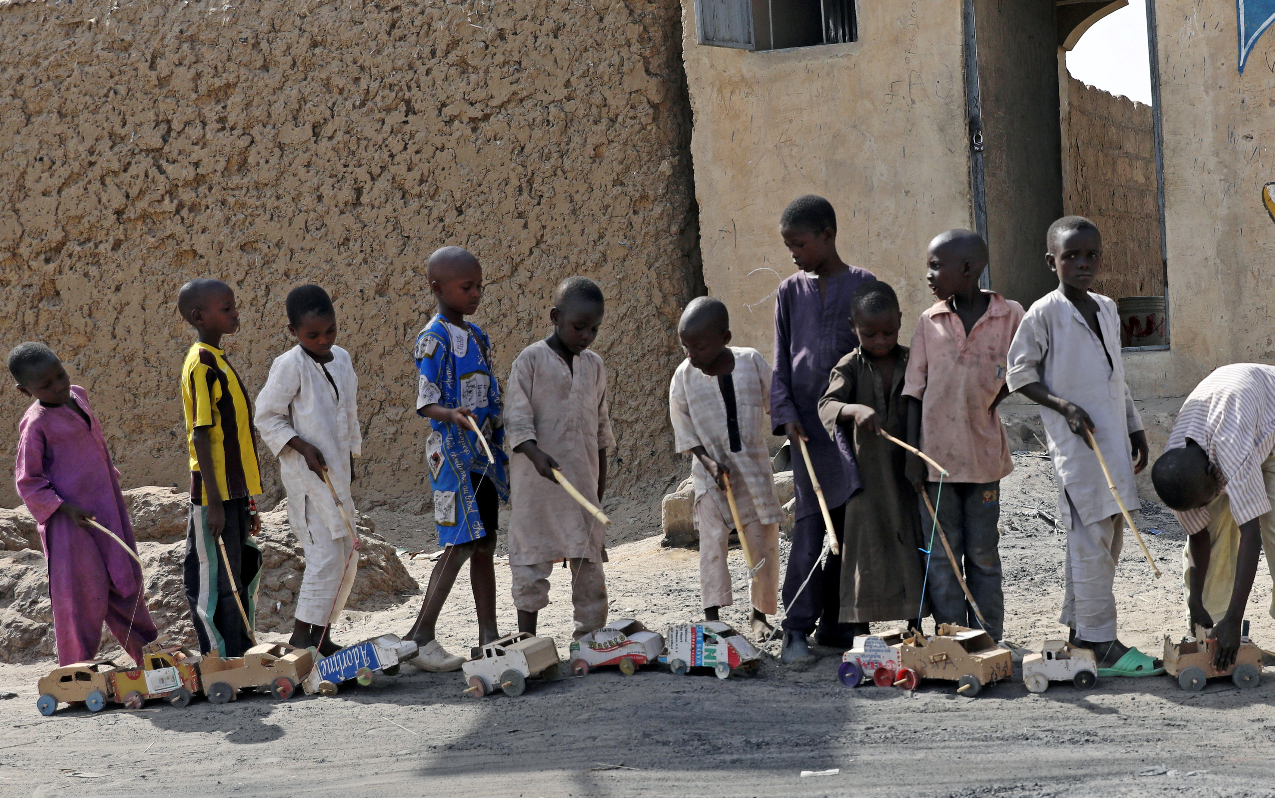 Boys play outside a bakery in Dapchi, in the northeastern state of Yobe