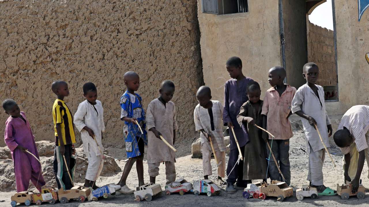 Boys play outside a bakery in Dapchi, in the northeastern state of Yobe