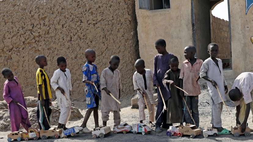 Boys play outside a bakery in Dapchi, in the northeastern state of Yobe
