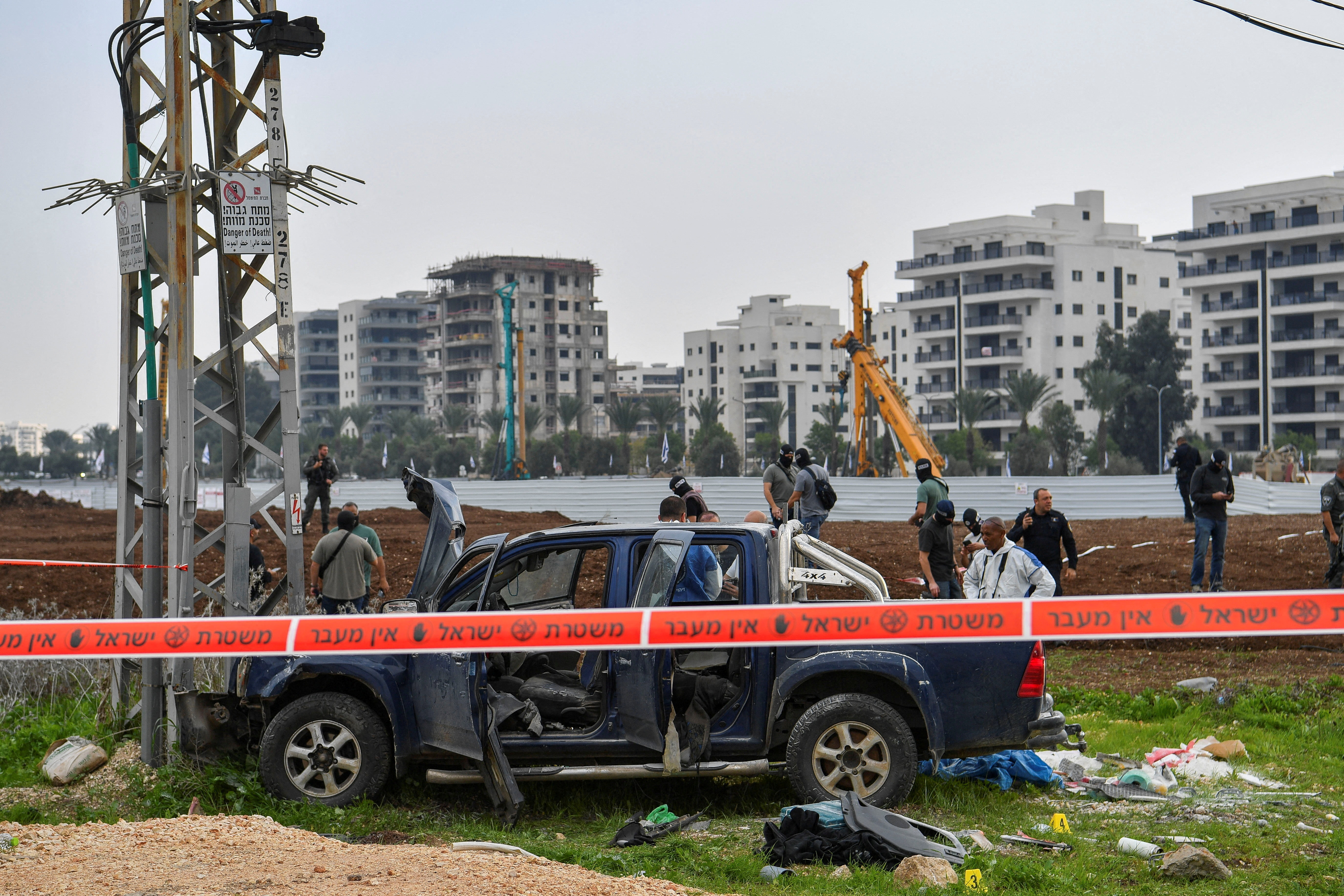 Israeli security forces inspect the scene where a vehicle was used by assailant in a suspected ramming and stabbing attack that killed two people in northern Israel according to Israeli authorities, in Afula