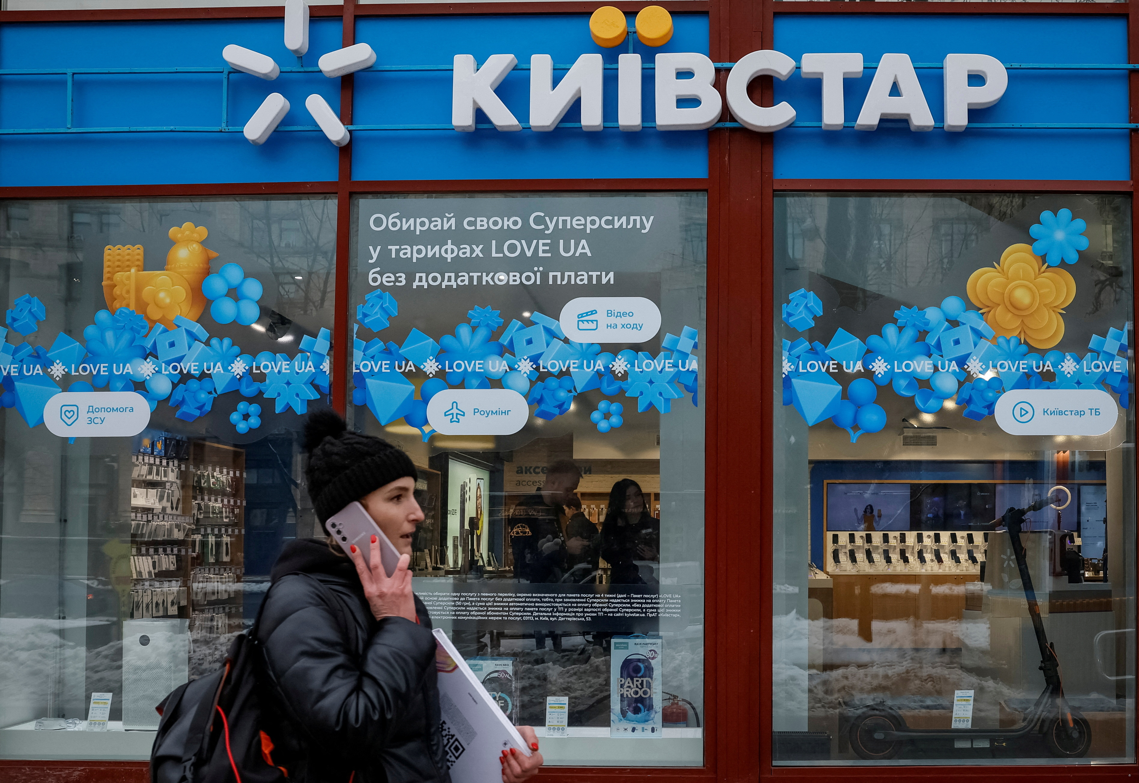 FILE PHOTO: Woman walks past a Kyivstar store in Kyiv