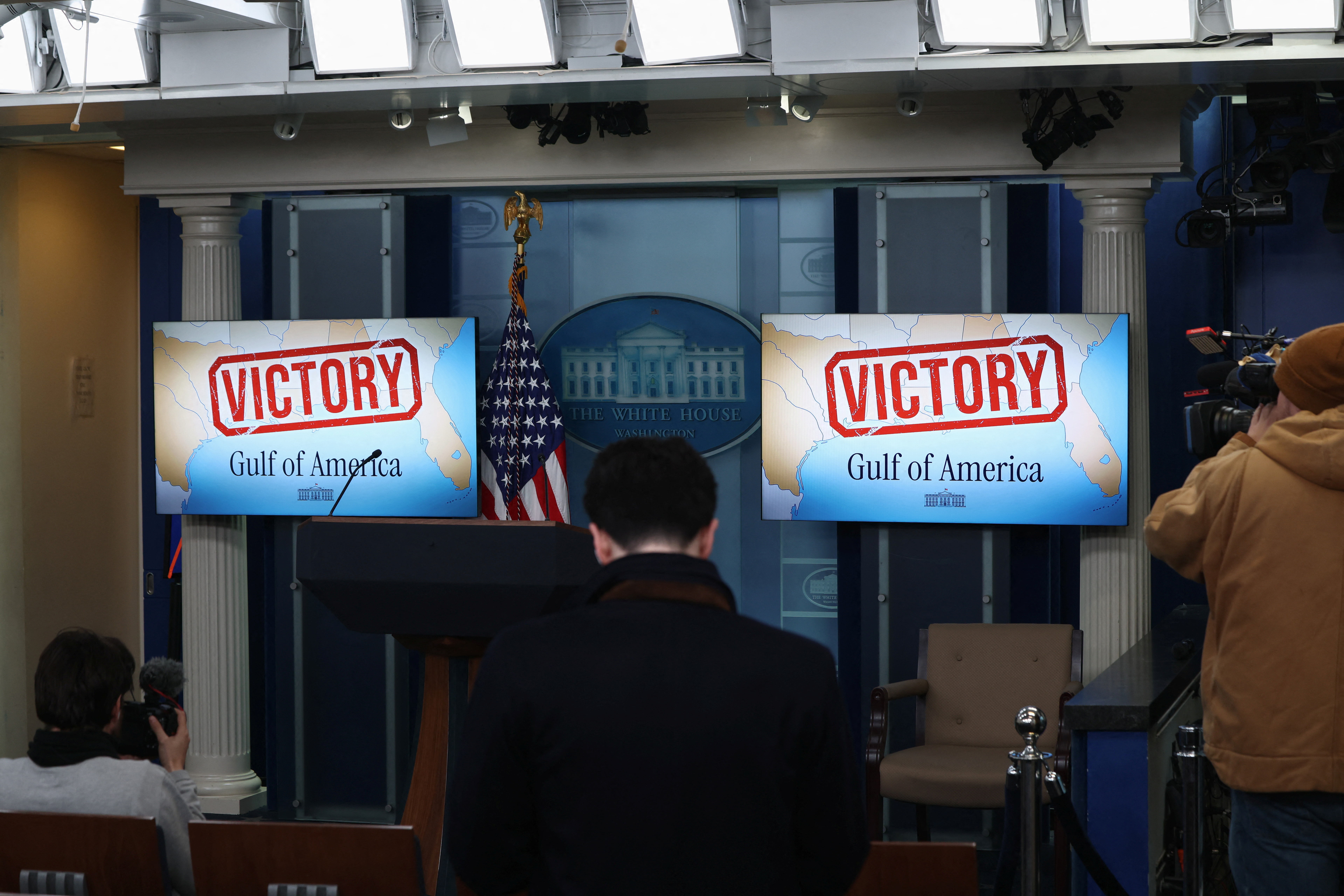 TV screens in the White House briefing room display the words "Victory" in Washington
