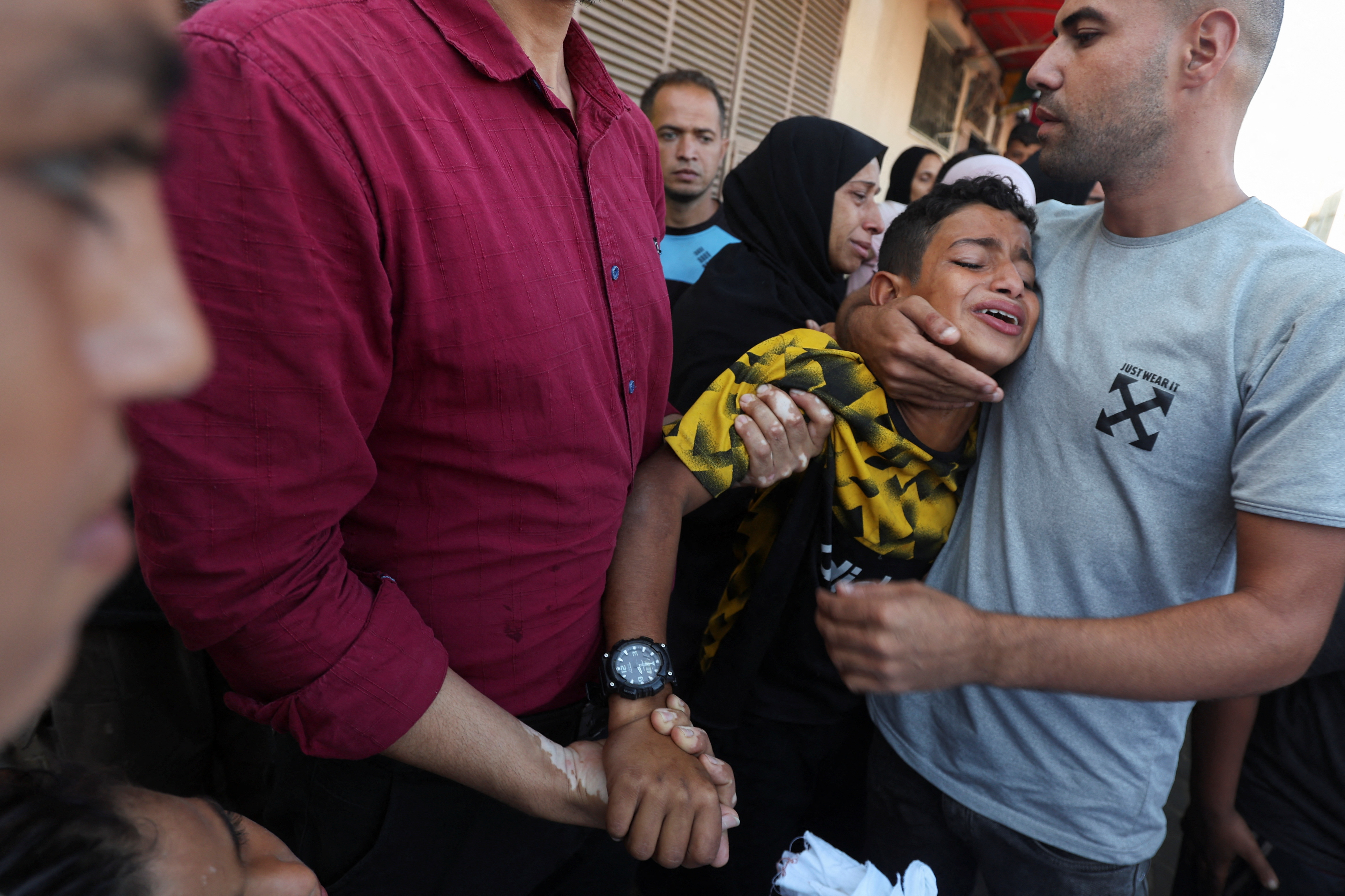 Palestinians mourn loved ones killed in Israeli strikes, in Deir Al-Balah in the central Gaza Strip