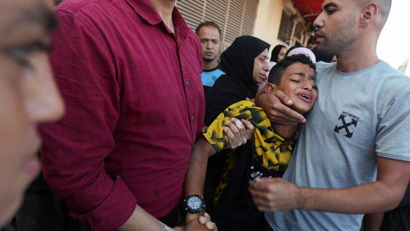 Palestinians mourn loved ones killed in Israeli strikes, in Deir Al-Balah in the central Gaza Strip