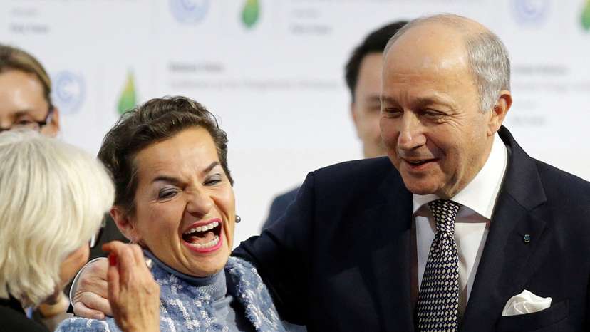 FILE PHOTO: French Foreign Affairs Minister Laurent Fabius, President-designate of COP21, and Christiana Figueres react at the World Climate Change Conference 2015 (COP21) at Le Bourget