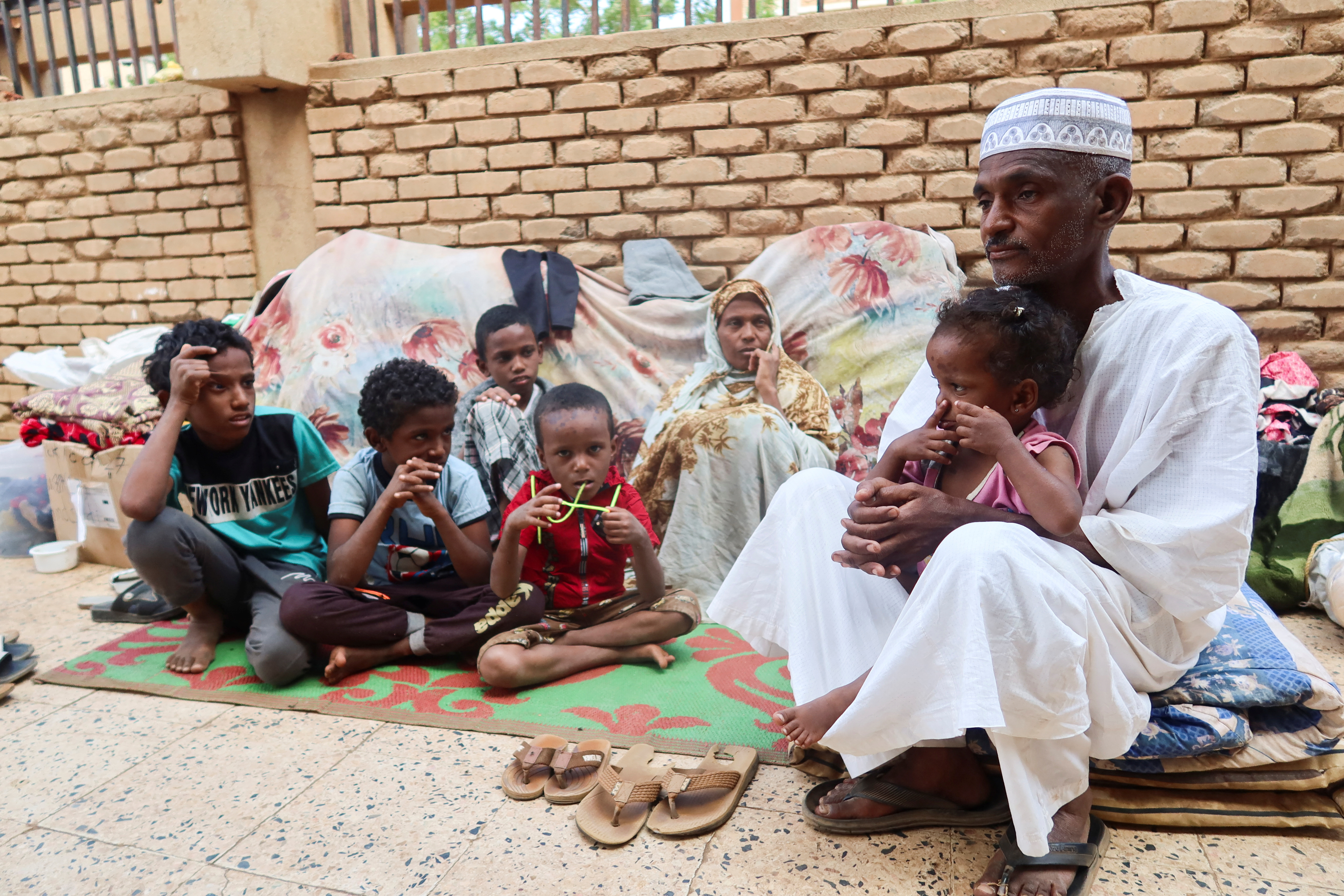 Muhammad Awad and his family rest after leaving Tuti Island, which is controlled by Rapid Support Forces (RSF), in Omdurman