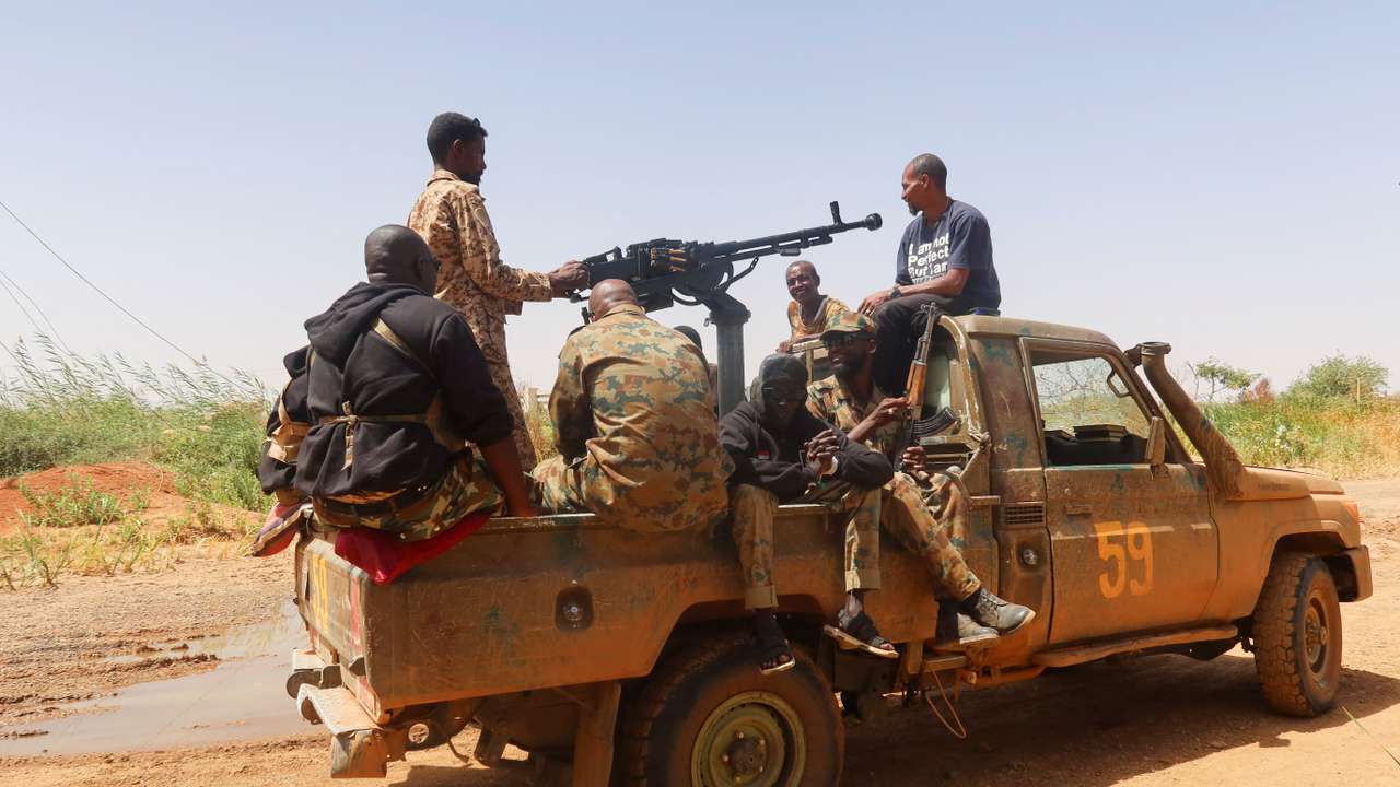 FILE PHOTO: Members of Sudanese armed forces sit on an army vehicle in Omdurman