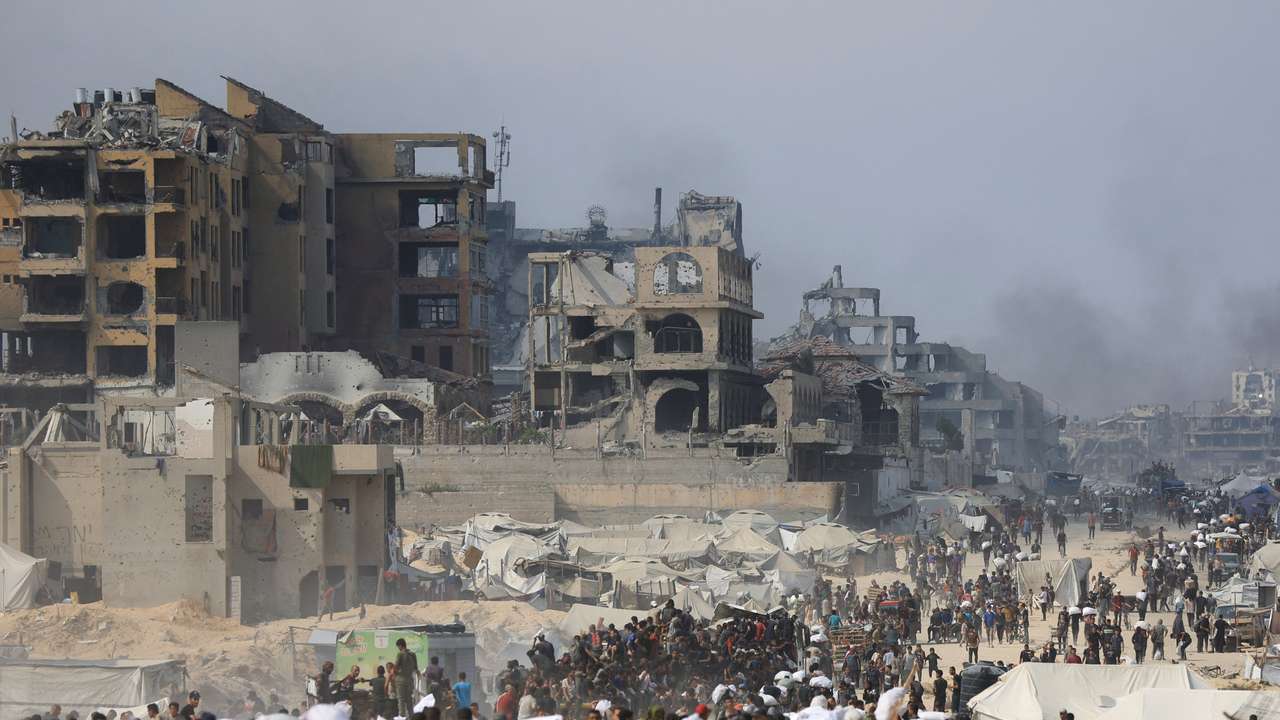 Palestinians seek aid supplies from trucks that entered Gaza through Israel, in Beit Lahia, in the northern Gaza Strip