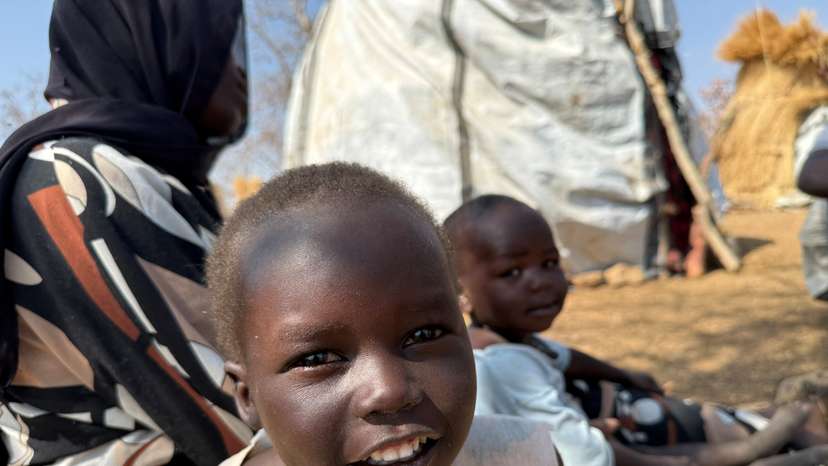 A boy reacts as he sits with his family displaced from Kadugli at Embal Camp in Engpung County