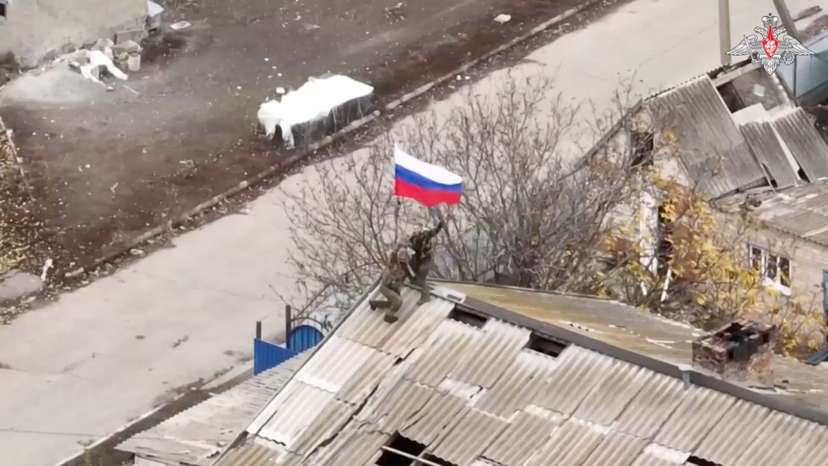 Russian soldiers set up a national flag after taking control of the village of Uspenivka in Zaporizhzhia region