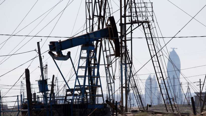 FILE PHOTO: A nodding donkey pumps oil in an oil field in the settlement of Balaxani