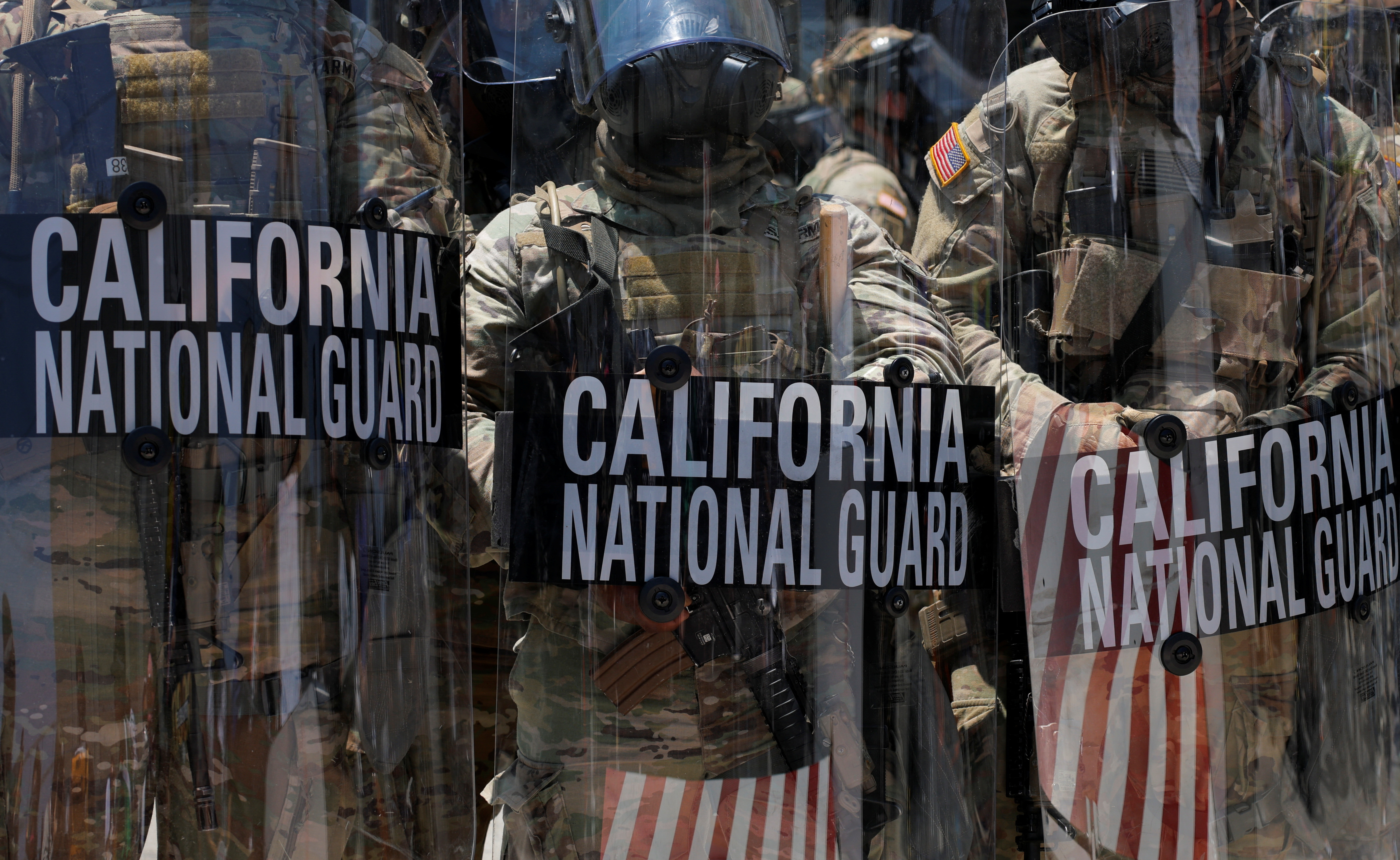 California National Guard troops stand outside the Edward R. Roybal federal building, in Los Angeles