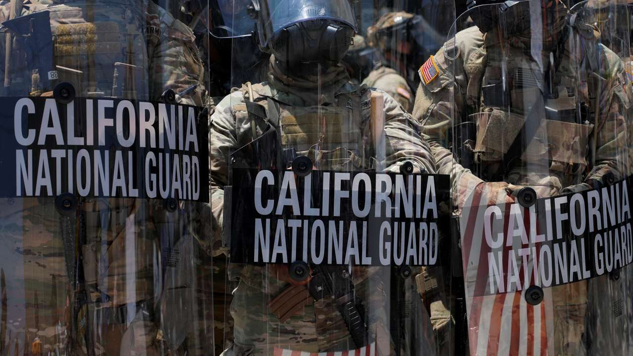 California National Guard troops stand outside the Edward R. Roybal federal building, in Los Angeles