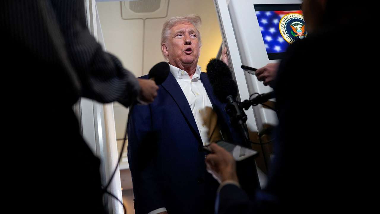 U.S. President Donald Trump speaks to the media on board Air Force One on the way to Palm Beach International Airport