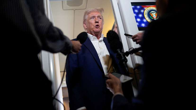 U.S. President Donald Trump speaks to the media on board Air Force One on the way to Palm Beach International Airport