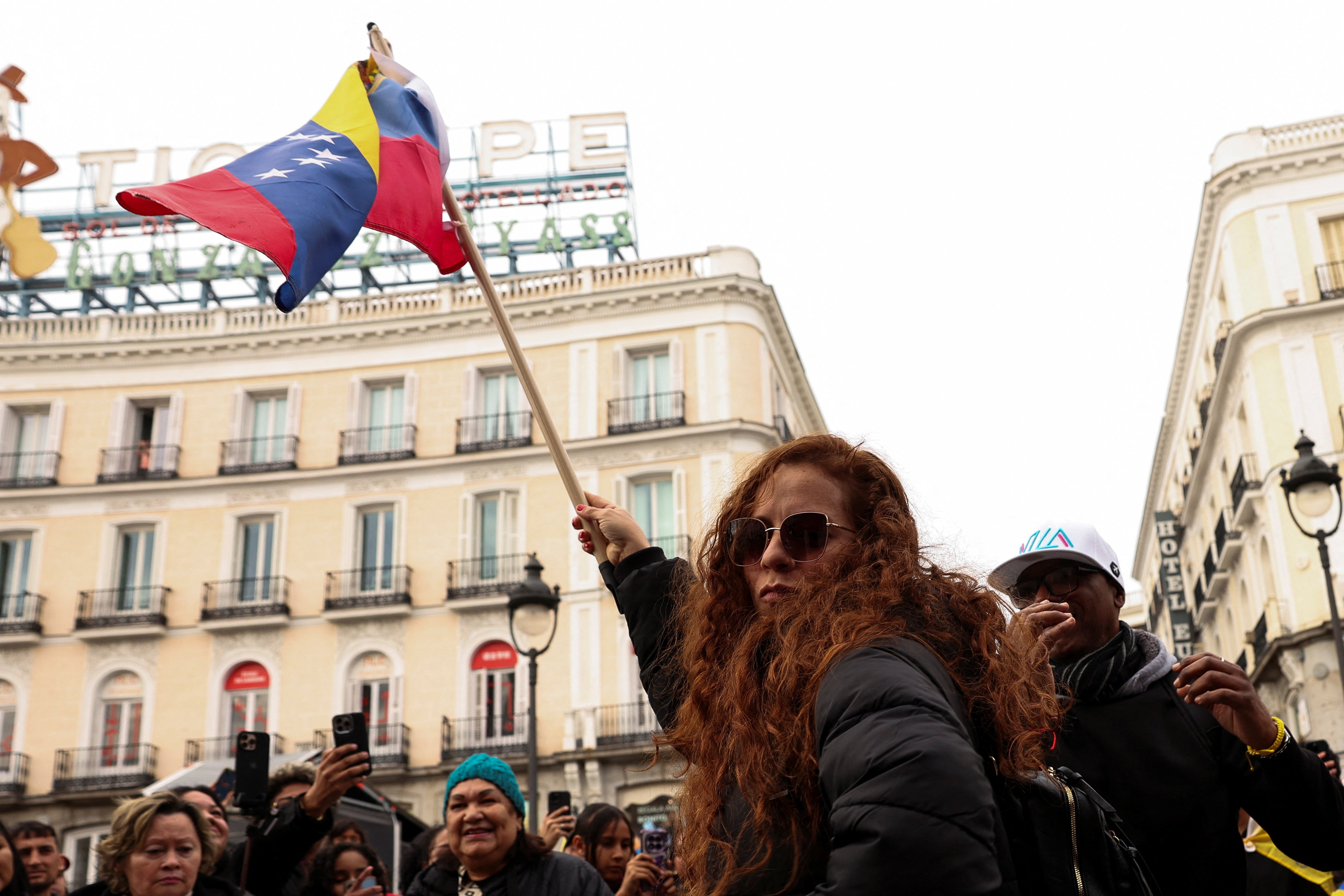 People react to the news of U.S. strikes on Venezuela and capture of President Maduro, in Madrid