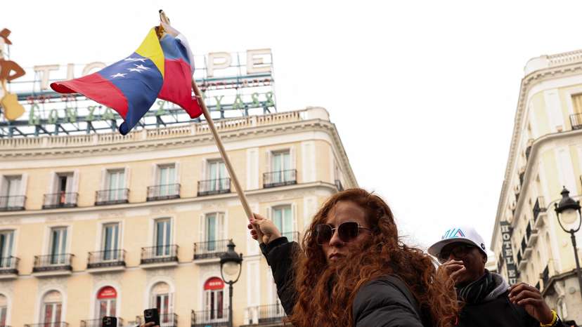People react to the news of U.S. strikes on Venezuela and capture of President Maduro, in Madrid