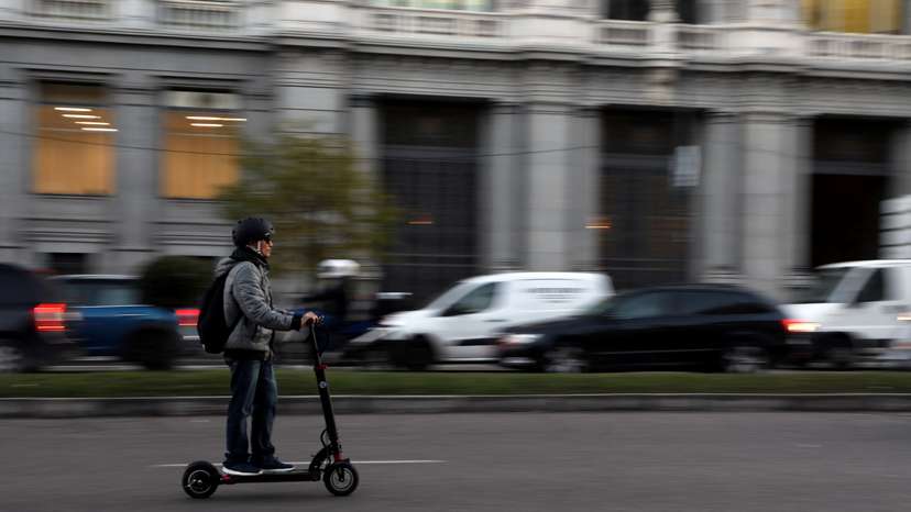 A man rides an electric scooter in Madrid