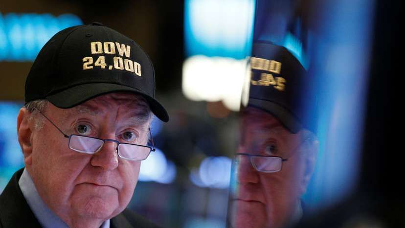 Art Cashin, Director of Floor Operations at UBS, wears a DOW 24,000 hat as he works on the floor of the NYSE as the Dow Jones Industrial Average crosses 24,000, in New York