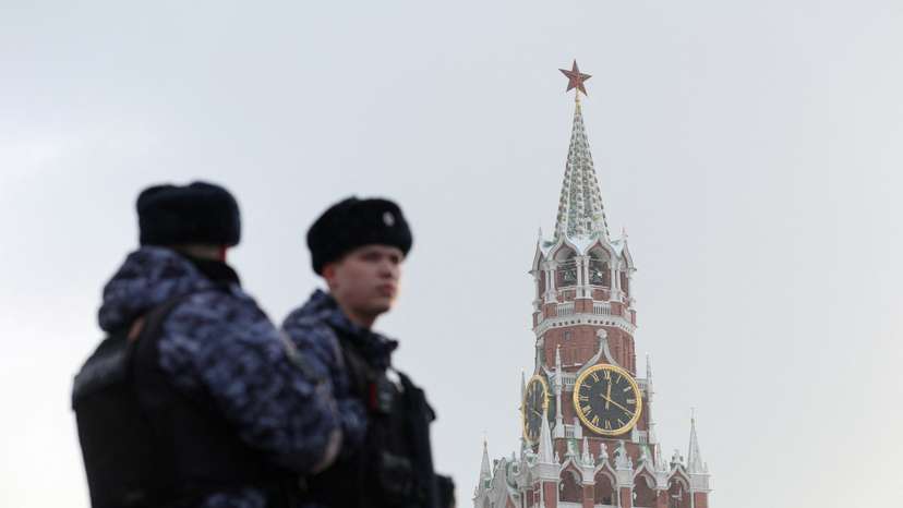 Russian law enforcement officers stand guard near Kremlin's Spasskaya Tower in Moscow
