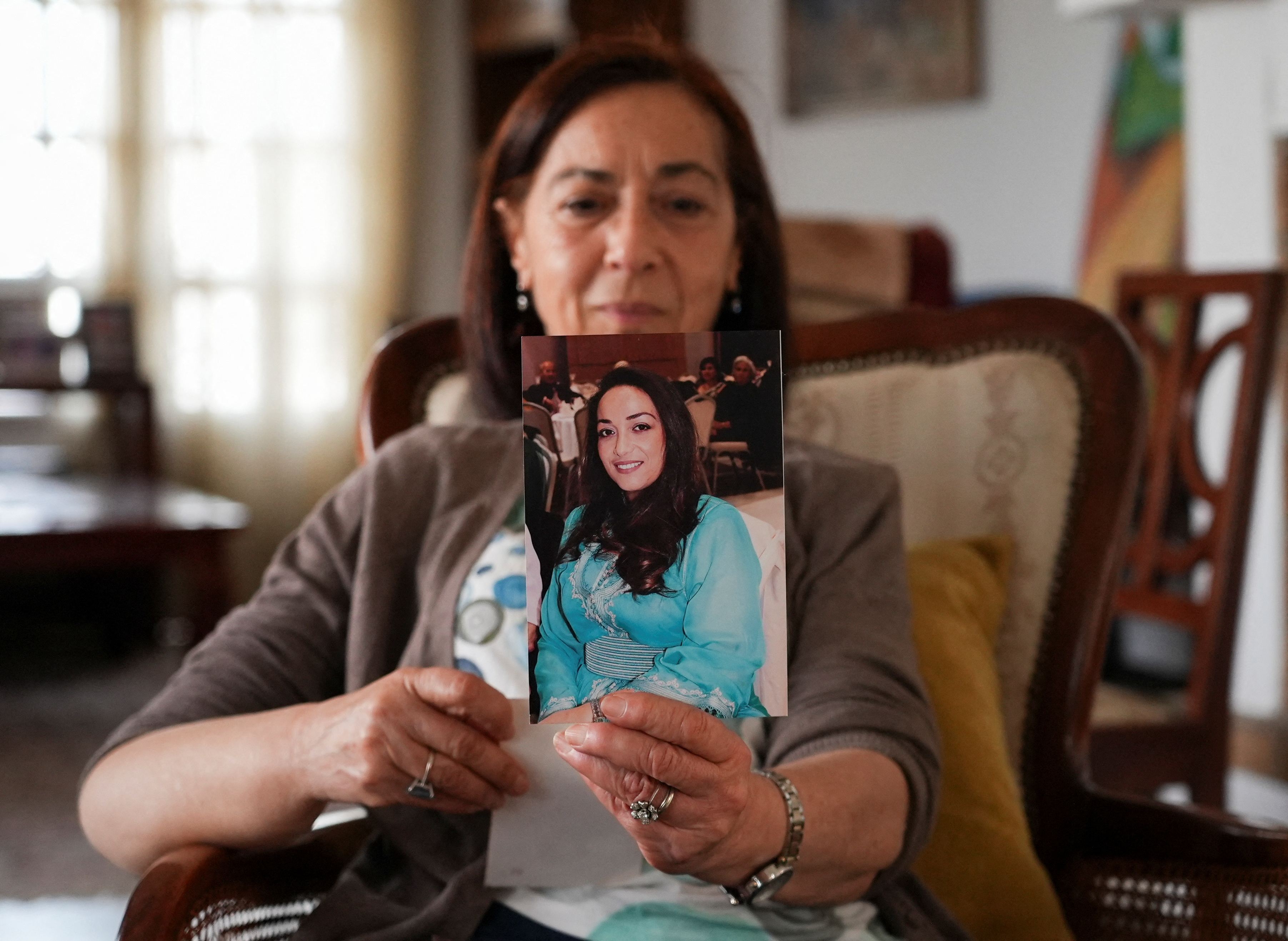 Tunisian activist Cherifa Riahi's mother Farida holds a picture of her daughter, Cherifa, at her house in Tunis