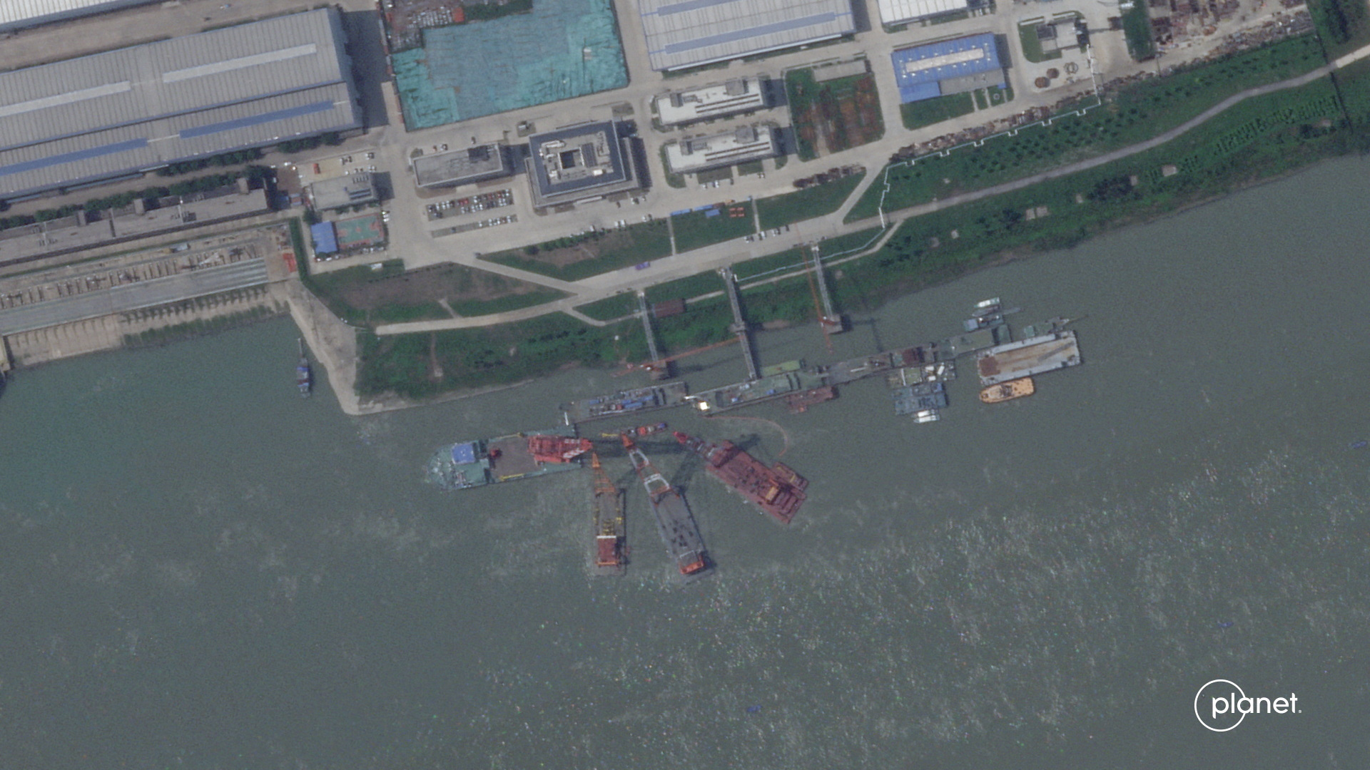 A series of satellite images from Planet Labs from June appear to show cranes at the Wuchang shipyard
