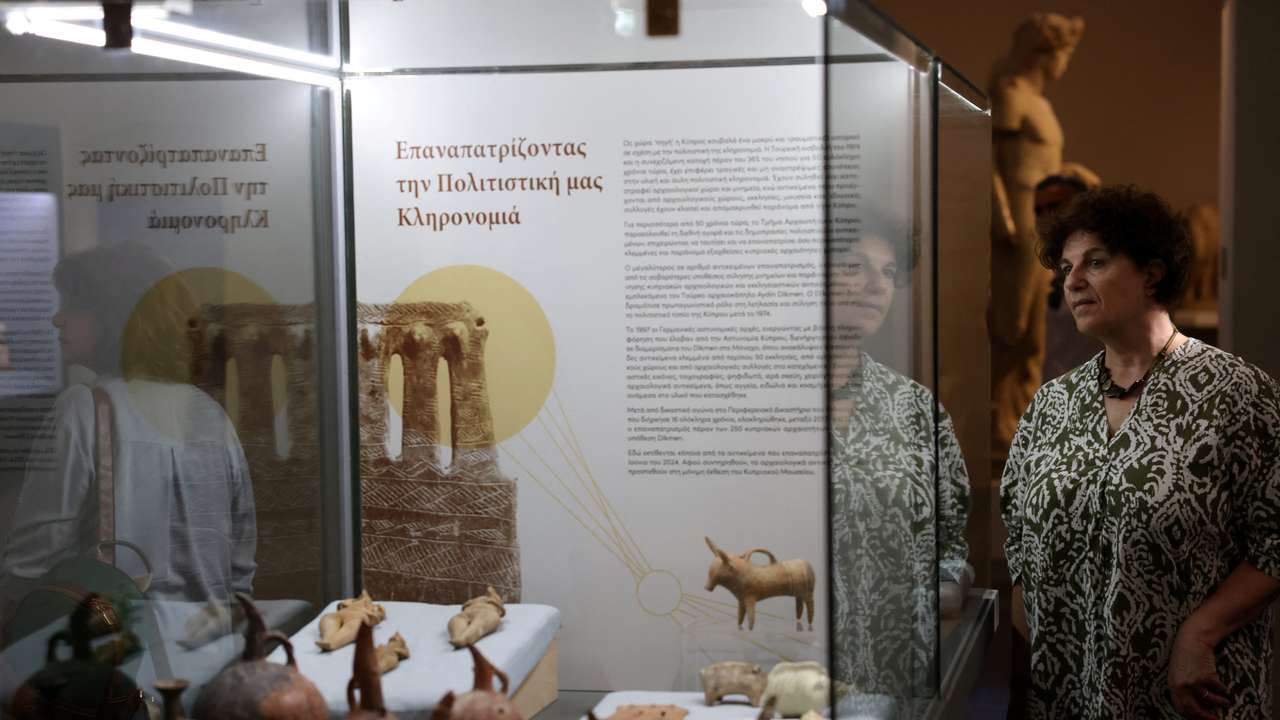 A woman looks at artefacts dating back to the Chalcolithic and Bronze Age period at the Cyprus Museum in Nicosia
