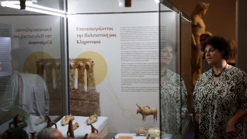 A woman looks at artefacts dating back to the Chalcolithic and Bronze Age period at the Cyprus Museum in Nicosia
