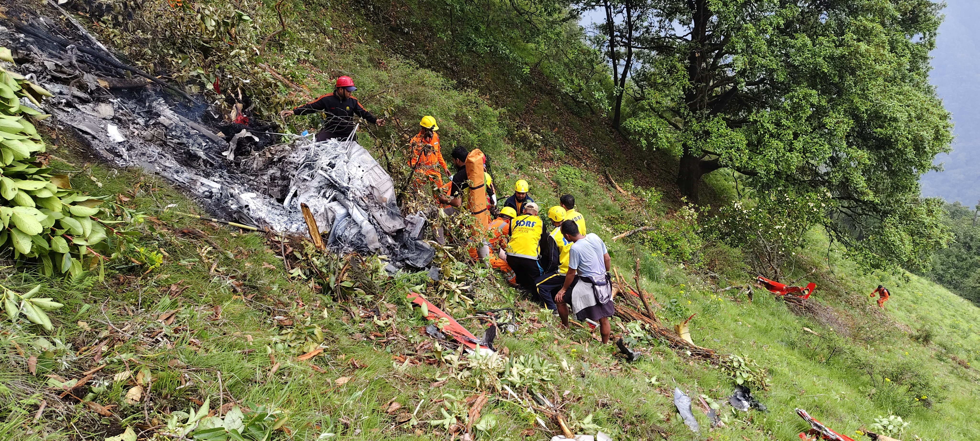 Members of rescue teams work at the site of a chopper crash in the Gaurikund area of the northern Indian state of Uttarakhand