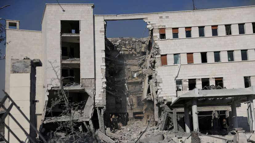 FILE PHOTO: People gather near a damaged site, in Damascus