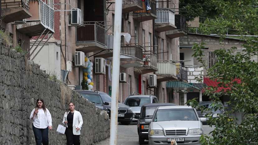 People walk along a street in Meghri