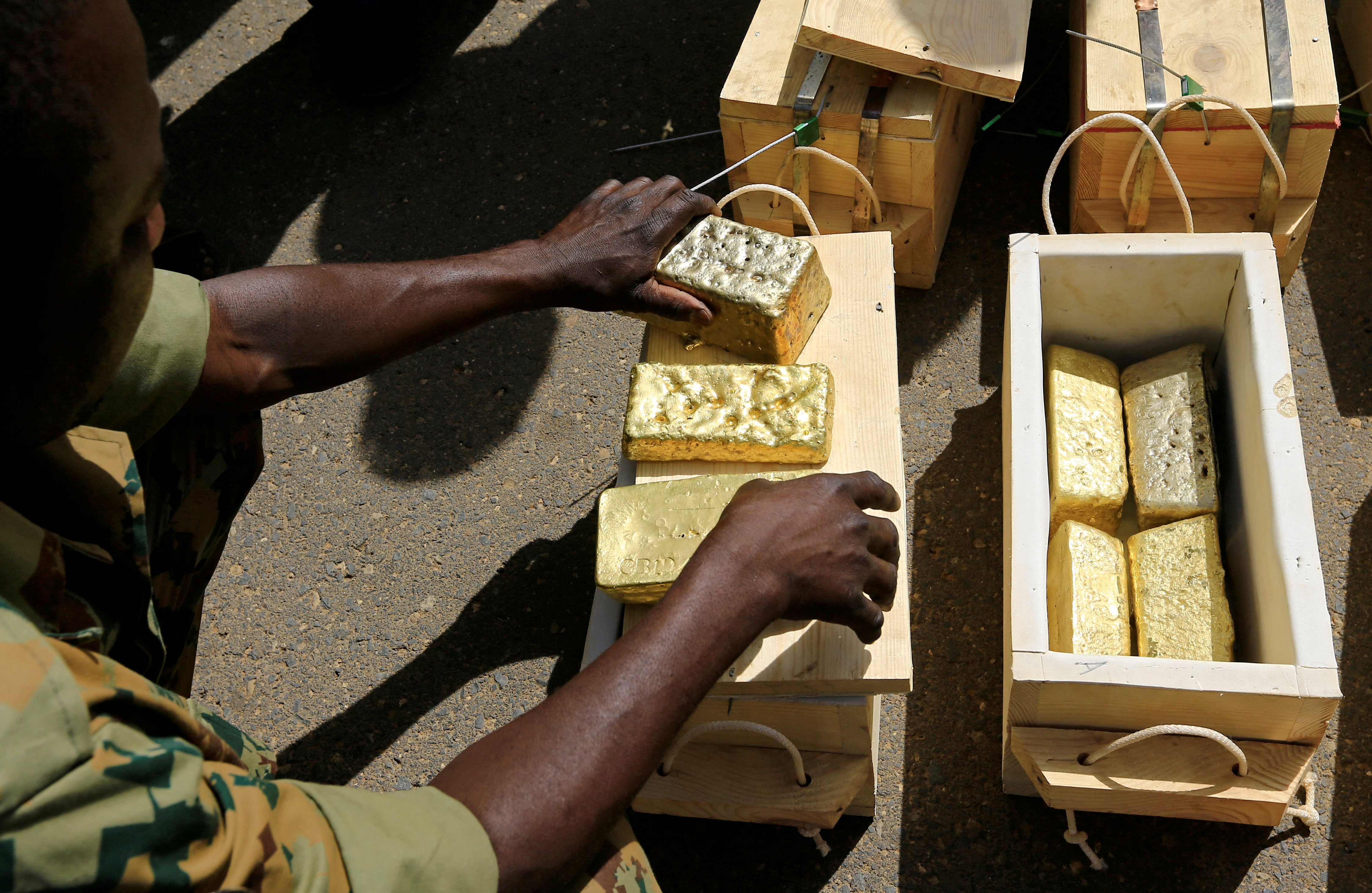 FILE PHOTO: Sudanese Rapid Support Forces (RSF) display gold bars seized from a plane that landed at Khartoum Airport in an investigation into possible smuggling, in Khartoum