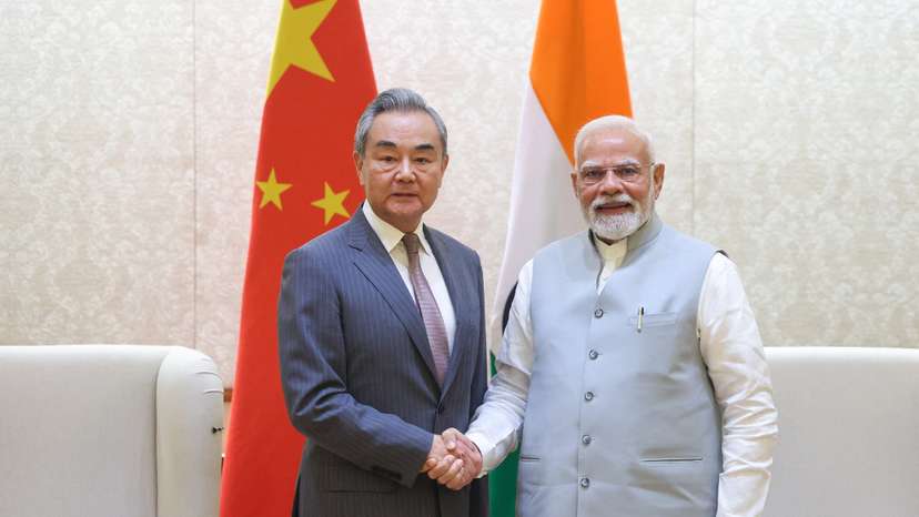 India's Prime Minister Narendra Modi shakes hand with Chinese Foreign Minister Wang Yi during their meeting in New Delhi