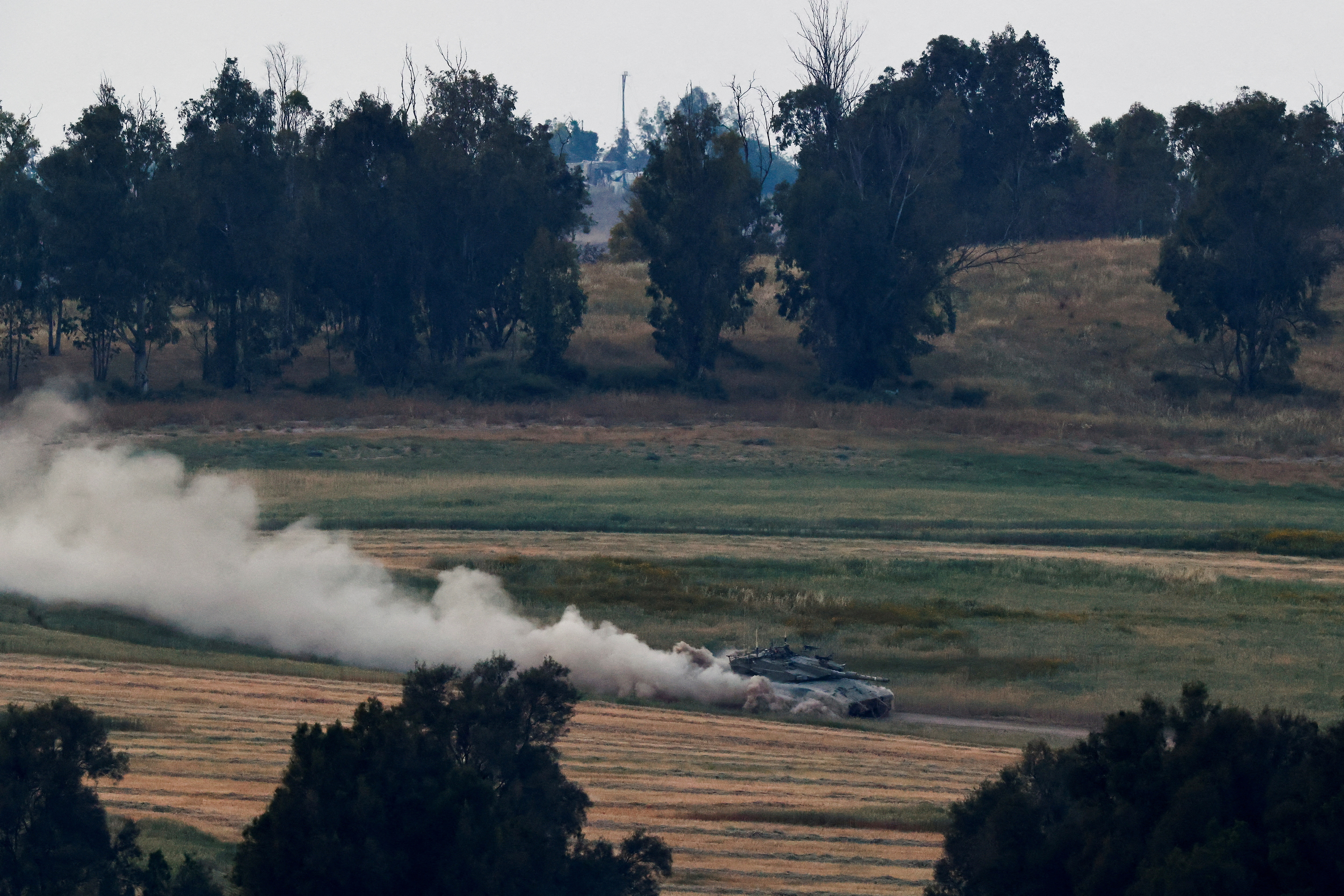Israeli soldiers patrol in a tank near the Israel-Gaza border