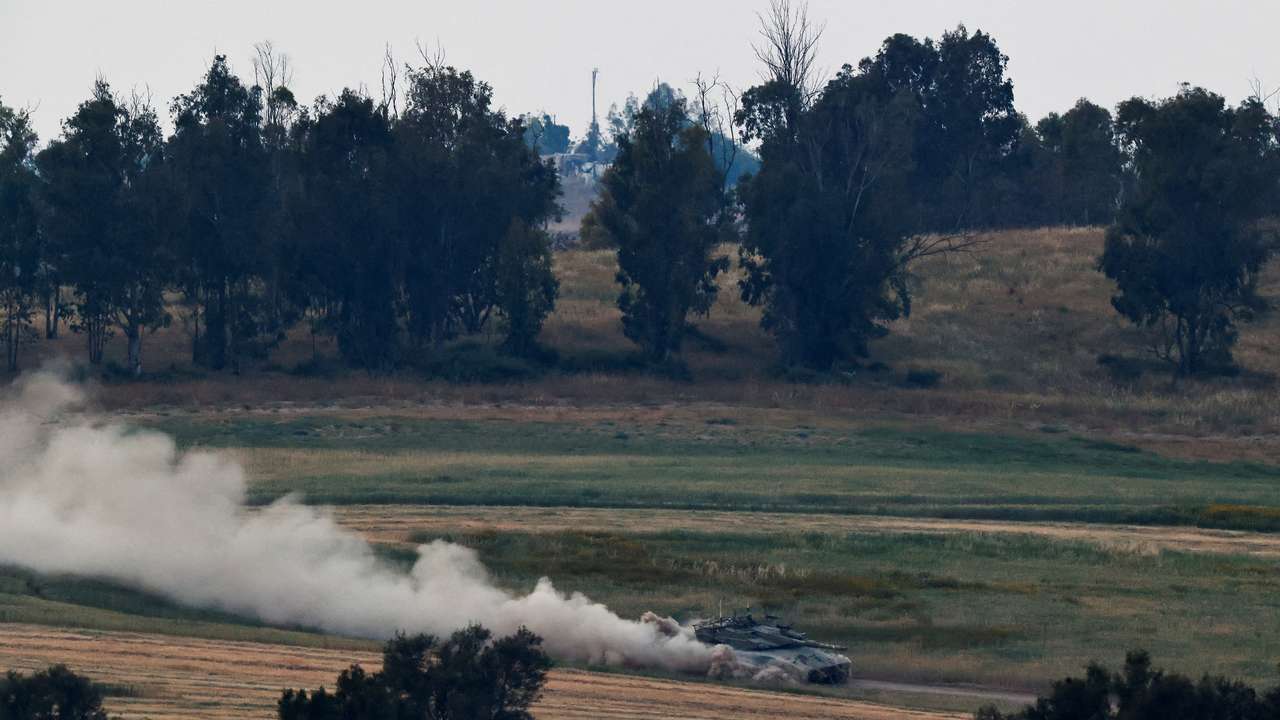 Israeli soldiers patrol in a tank near the Israel-Gaza border