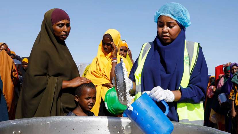 Internally displaced Somalis queue to receive iftar food rations during Ramadan, in the outskirt of Mogadishu