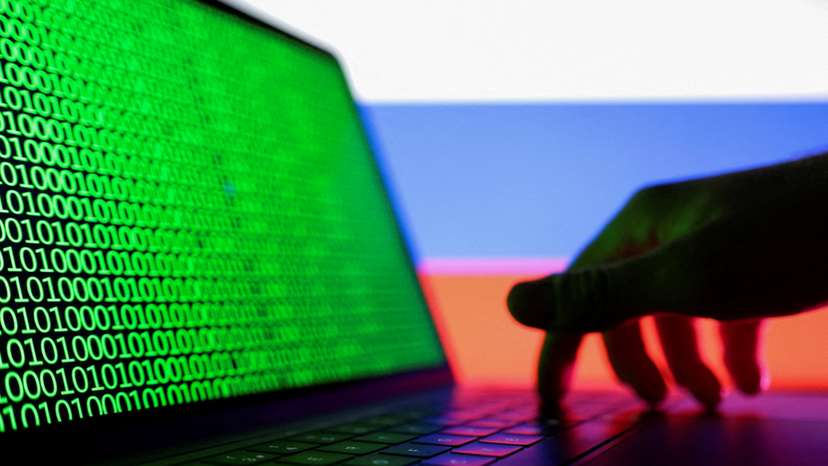 FILE PHOTO: Illustration shows laptop with binary code on the screen in front of Russian flag
