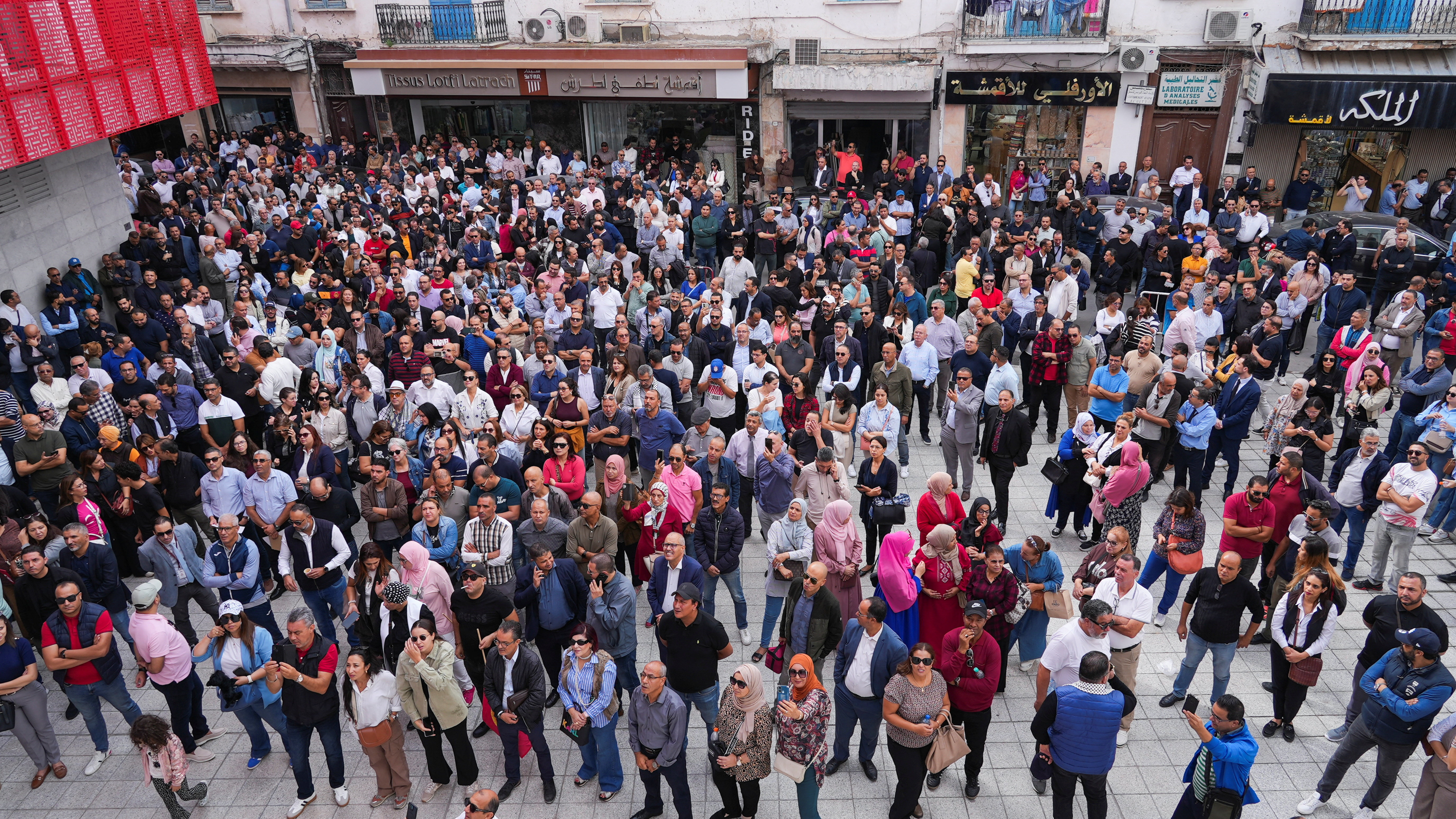 Tunisian bank employees gather in front of the Tunisian General Labour Union (UGTT) headquarters during a strike to demand salary increases, in Tunis