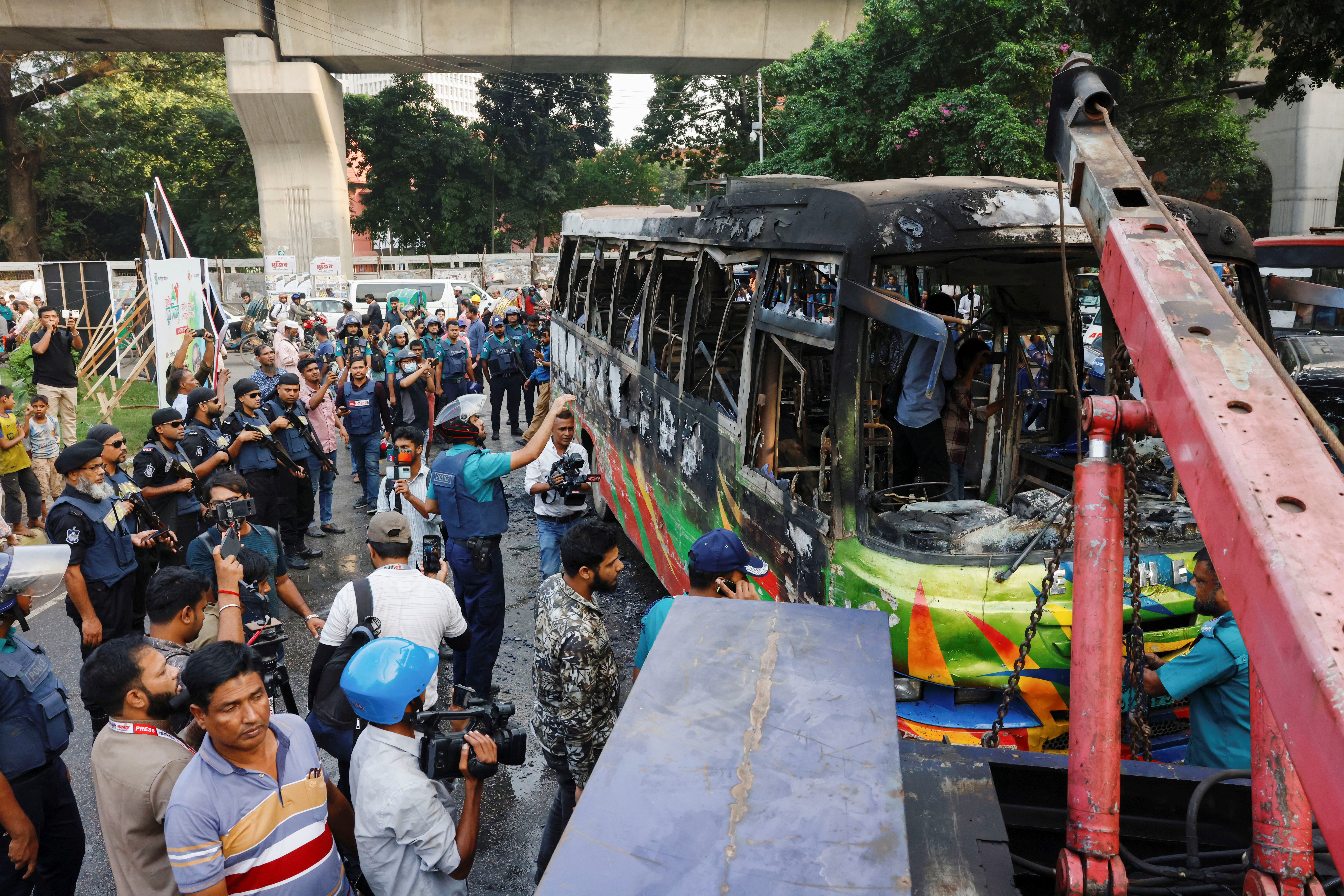 A public bus burns after it was set on fire by unidentified people during a countrywide blockade in Dhaka