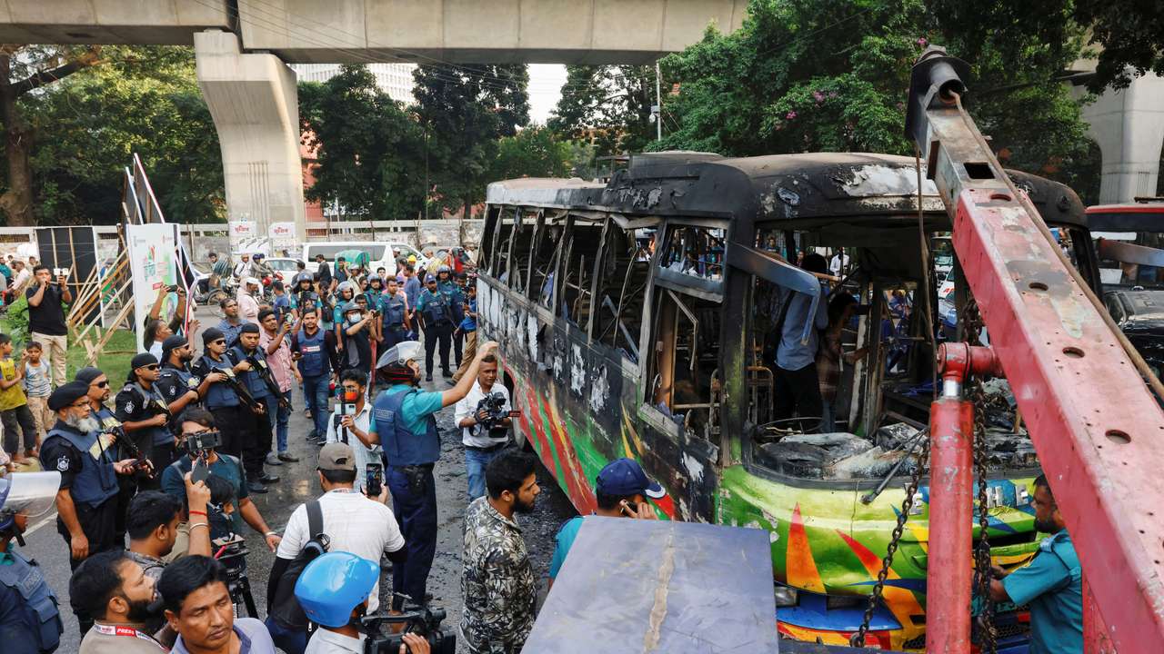 A public bus burns after it was set on fire by unidentified people during a countrywide blockade in Dhaka