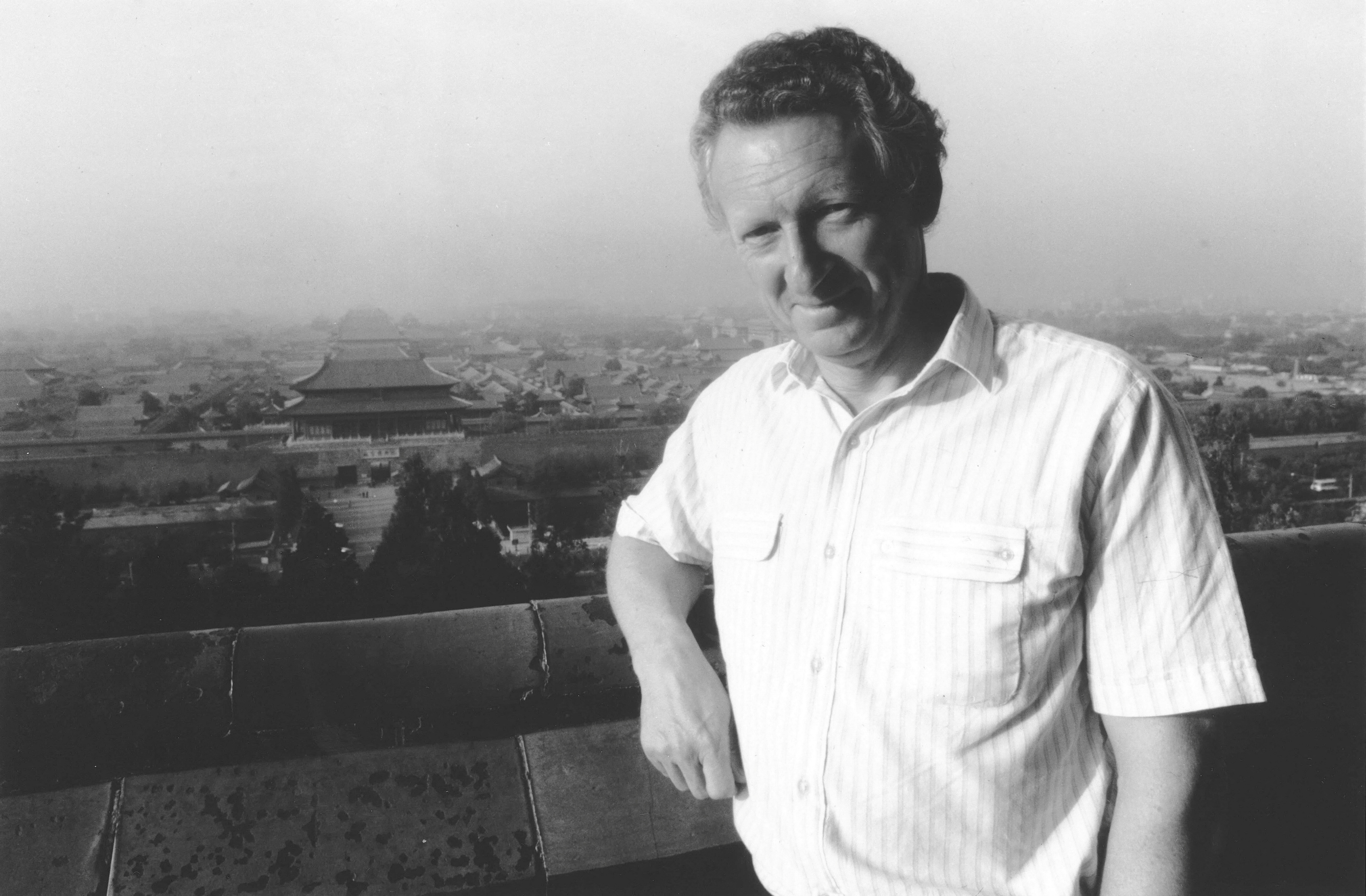 British journalist Anthony Grey poses in front of the Forbidden City, following his return to the country, in Beijing