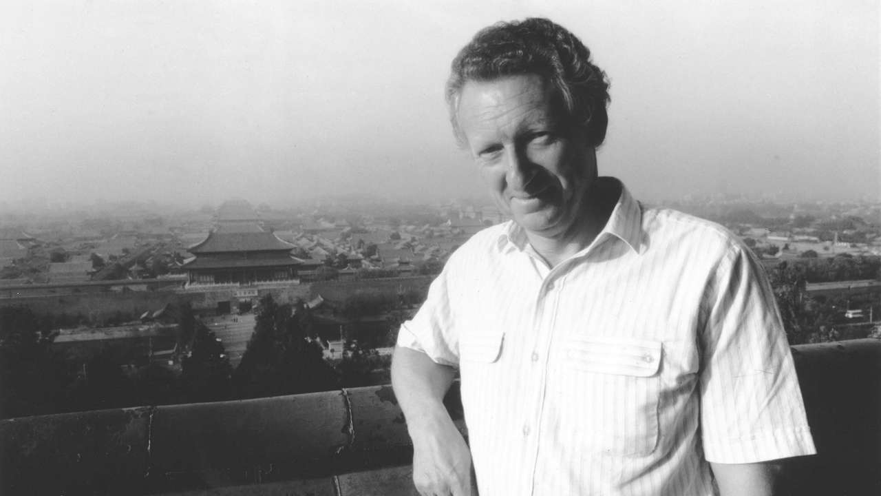 British journalist Anthony Grey poses in front of the Forbidden City, following his return to the country, in Beijing
