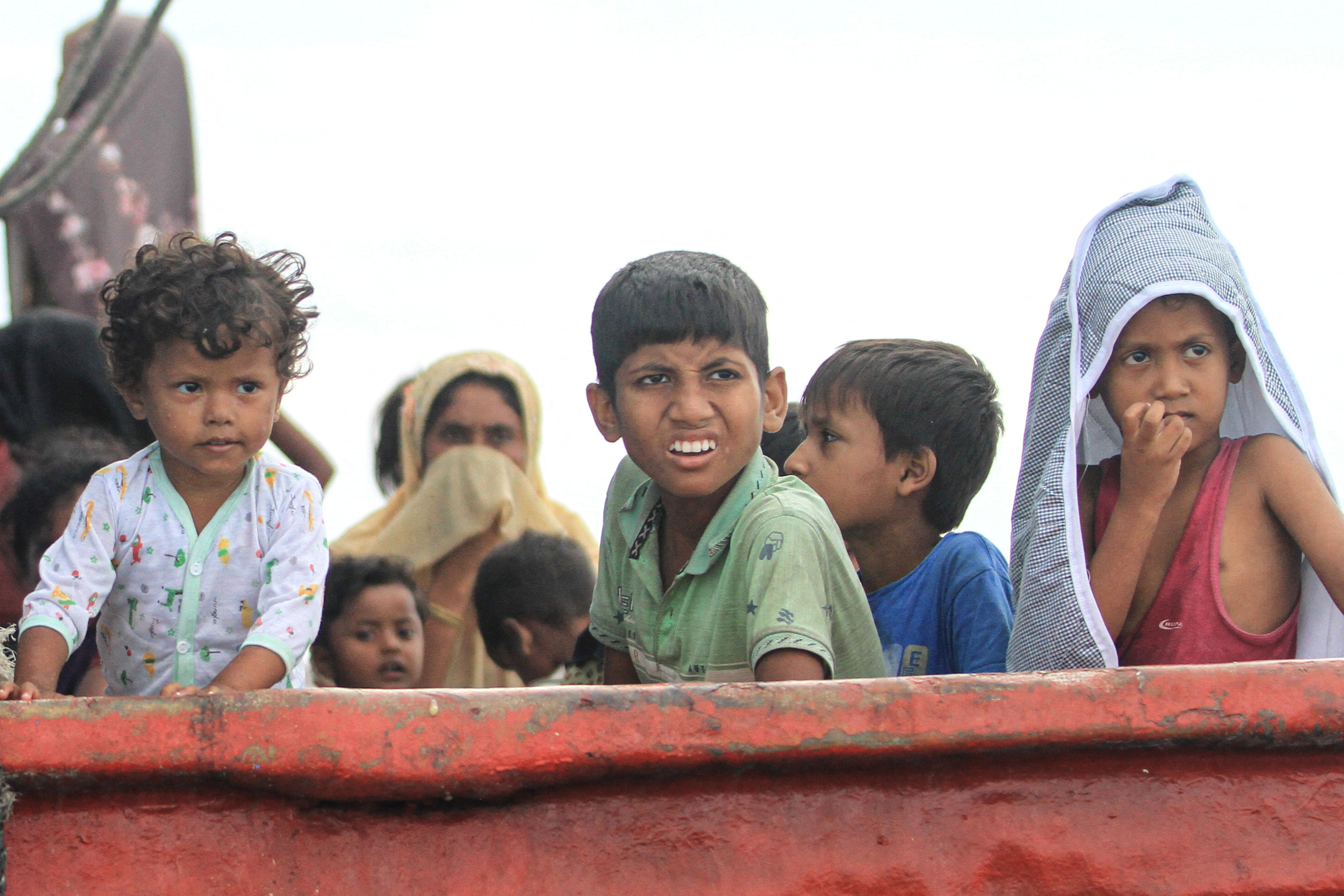 Rohingya refugee children are seen on a boat, after Rohingya refugees, mostly women and children, got stranded due to a boat engine failure in the waters of South Aceh